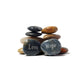 Stack of stones with 'Love' and 'Hope' inscribed on them against a white background