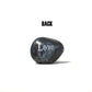 Marble-like stone with 'Love' engraved on a white background