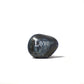 Decorative stone with 'Love' engraved on a white background