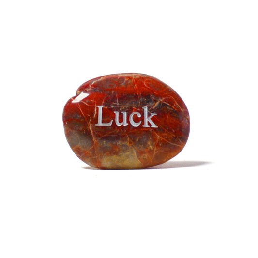 Marbled stone with 'Luck' engraved on a white background