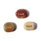 Three stones with 'Luck' engraved on them on a white background