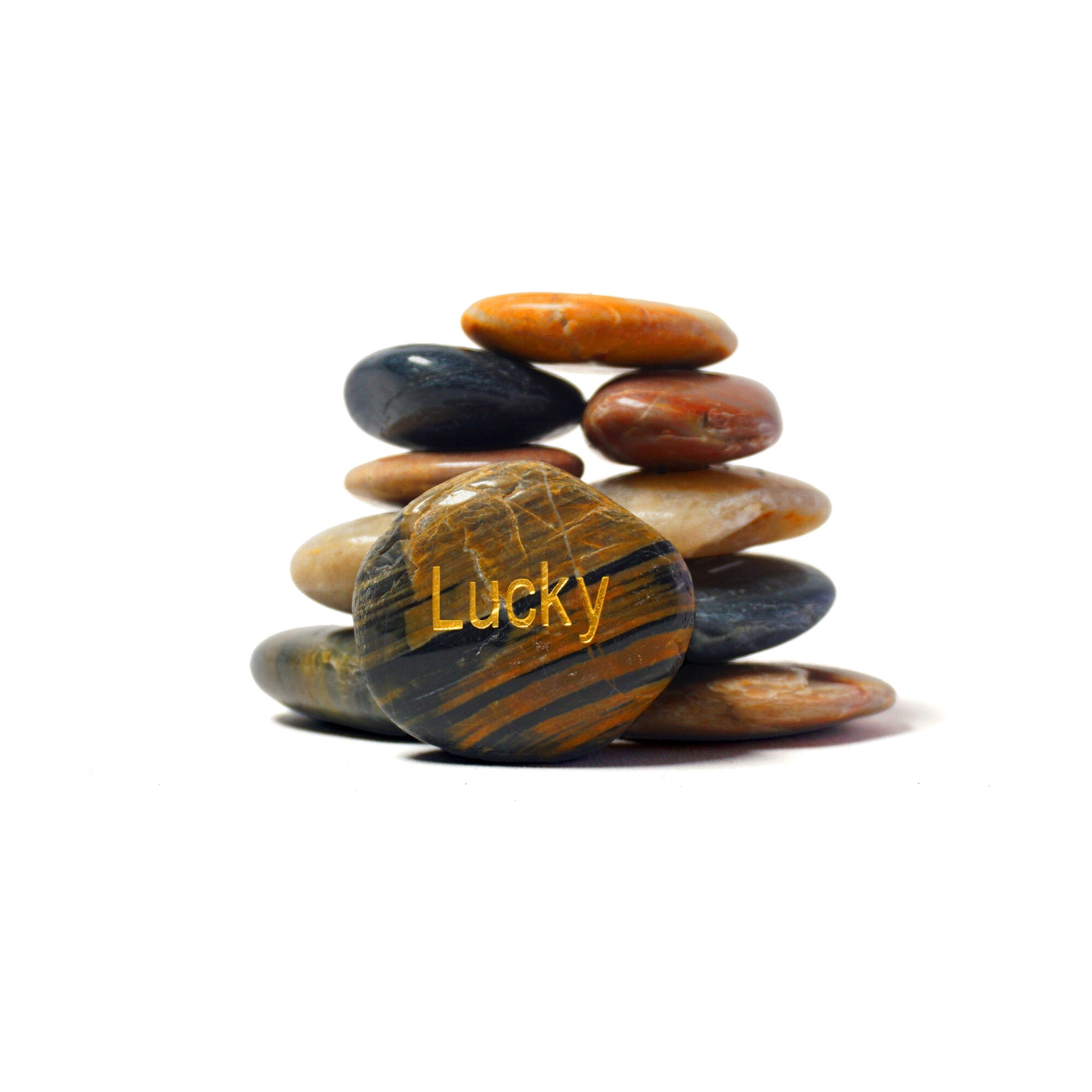 Stack of multicolored stones with 'Lucky' text on a white background