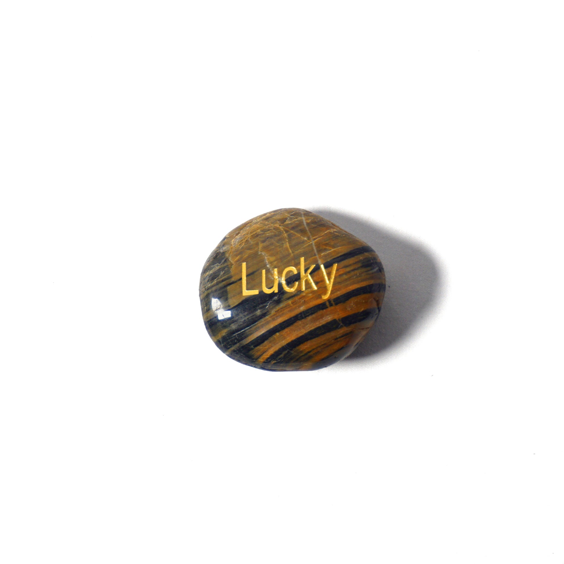 Tiger's eye stone with 'Lucky' engraved on a white background