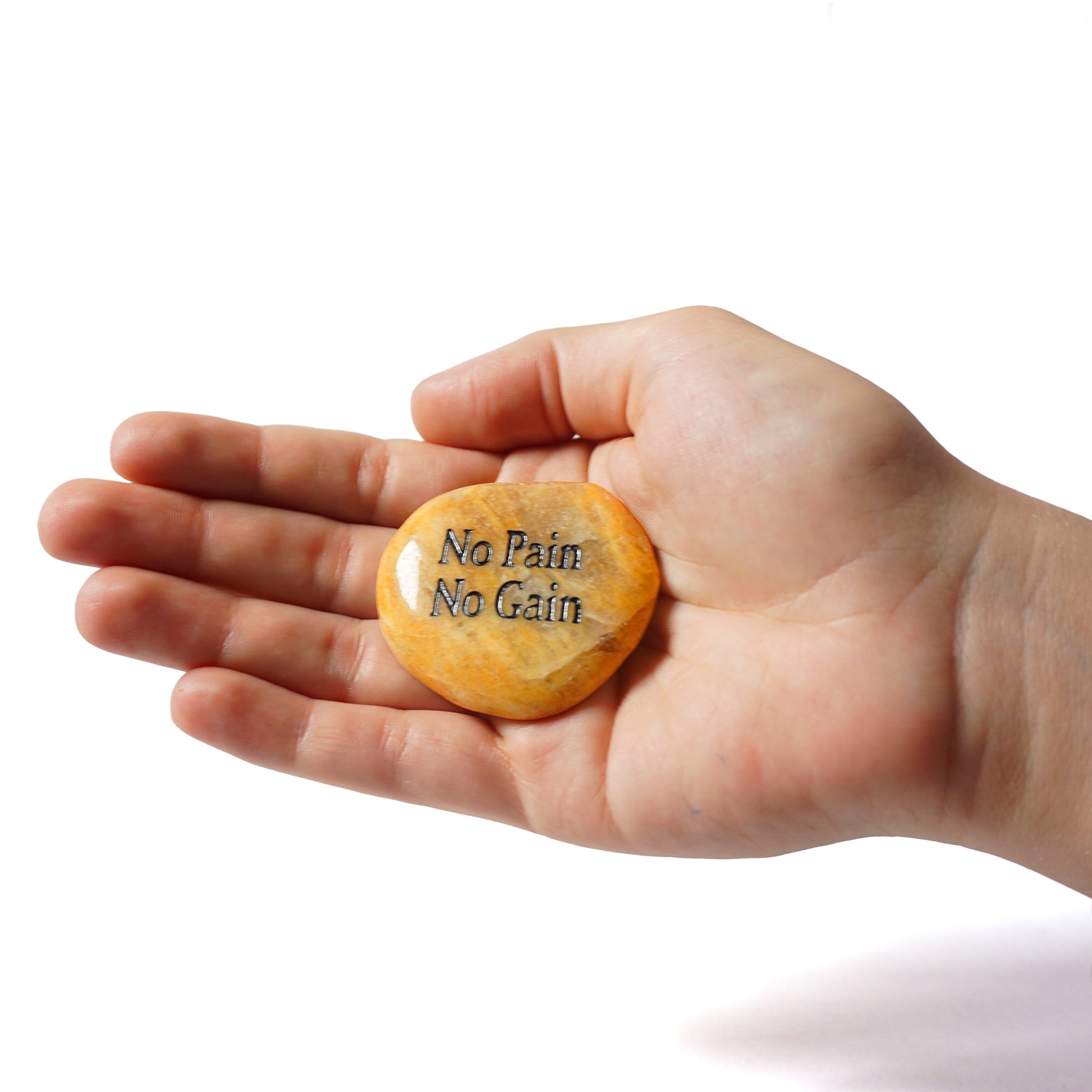 Hand holding a yellow stone with 'No Pain No Gain' text on a white background