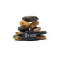 Stack of stones with 'Peace' engraved on a white background