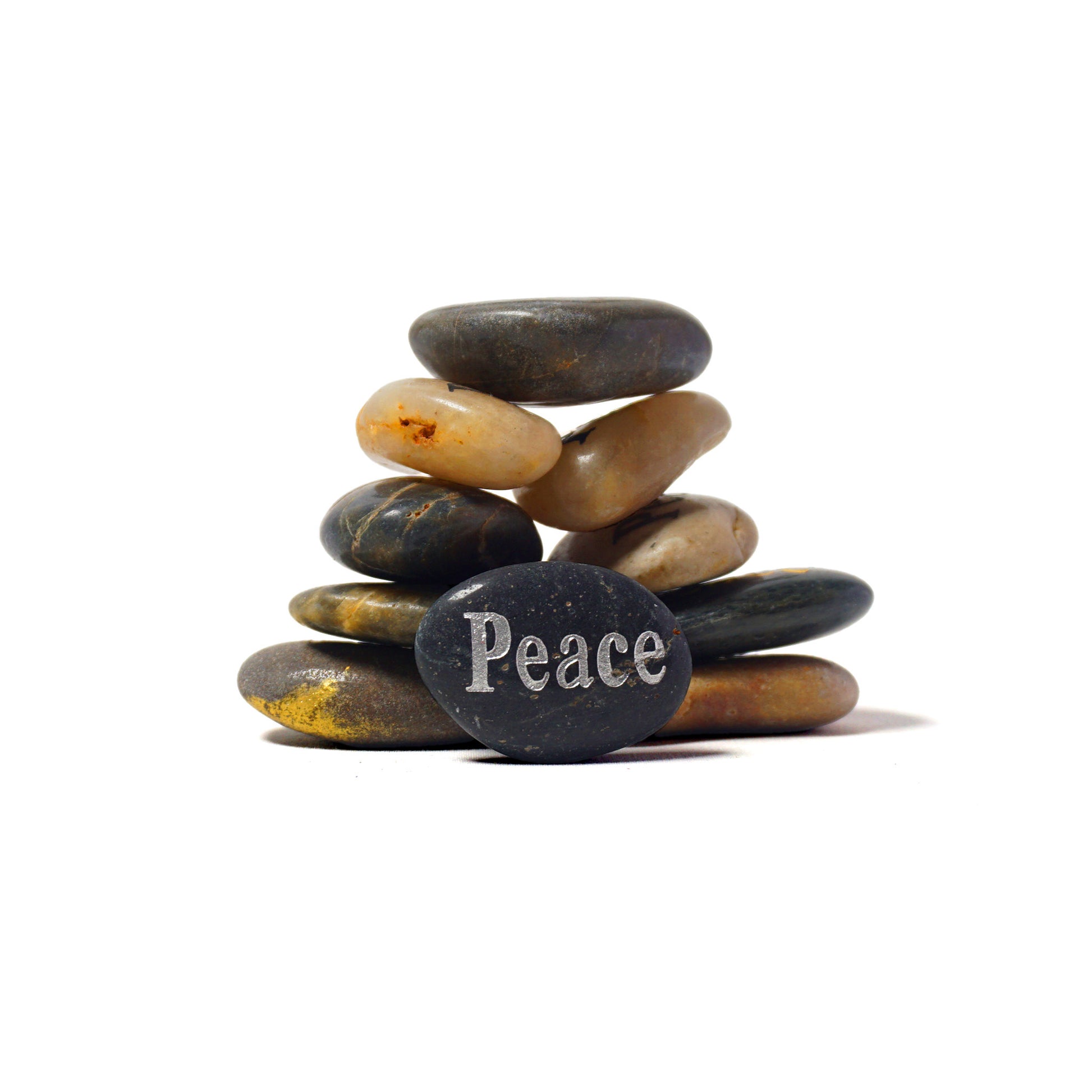Stack of stones with 'Peace' engraved on a white background