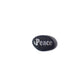 Black oval stone with 'Peace' engraved on a white background