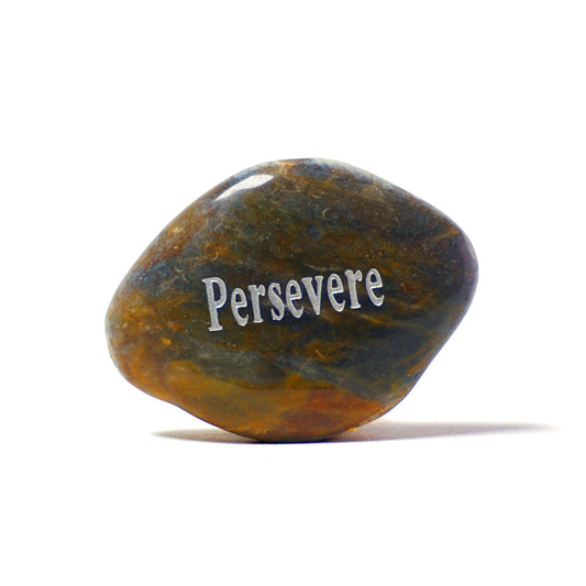 Rounded stone with 'Persevere' engraved on a white background