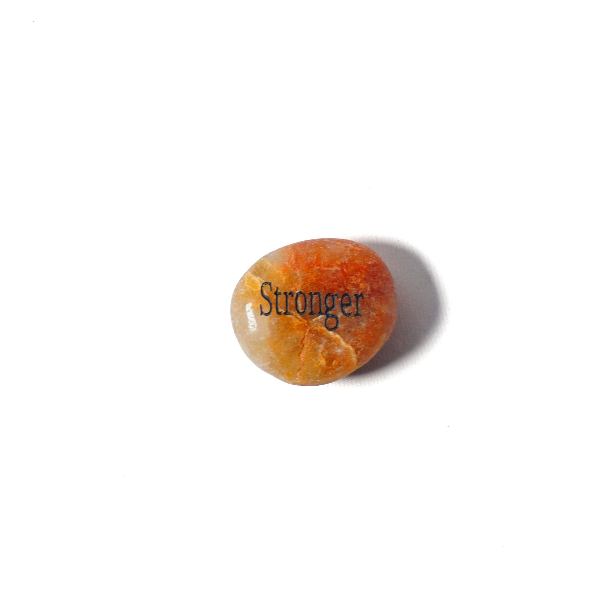 Orange stone with 'Stronger' engraved on a white background