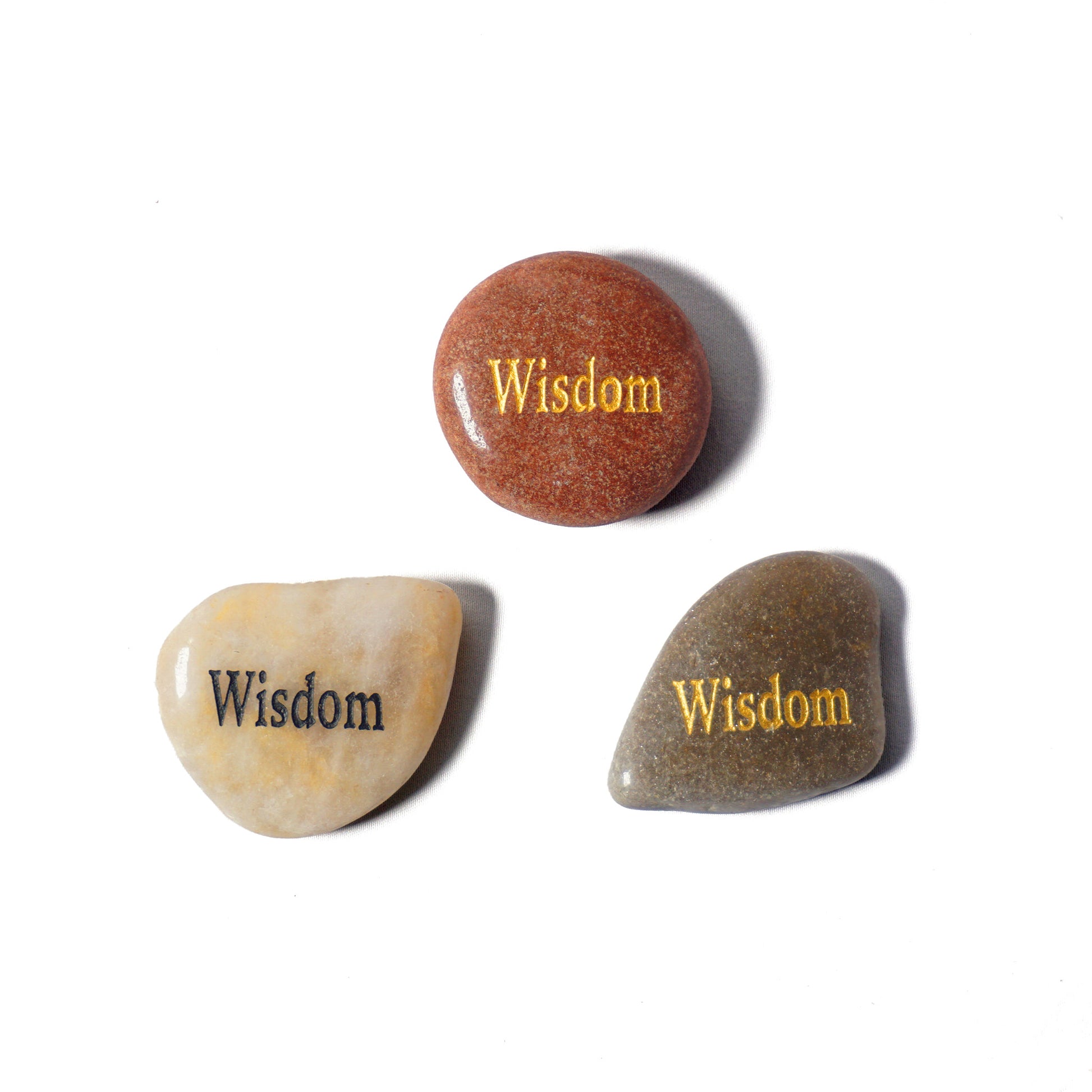 Three stones with 'Wisdom' engraved on them on a white background