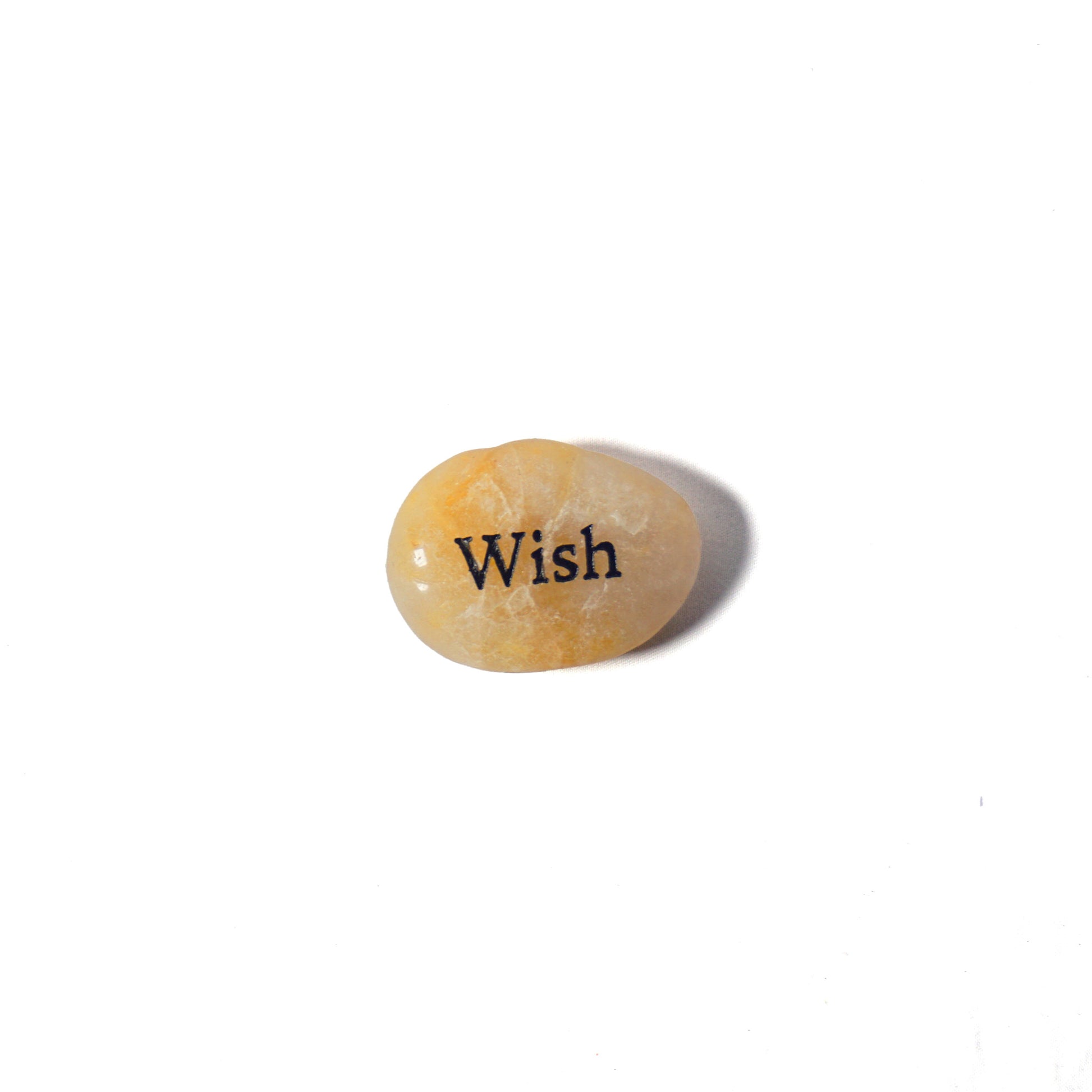 Small stone with 'Wish' engraved on a white background