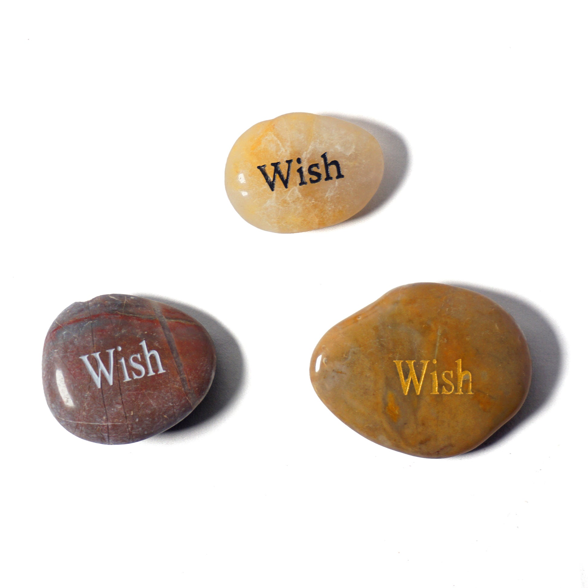 Three stones with 'Wish' engraved on them on a white background